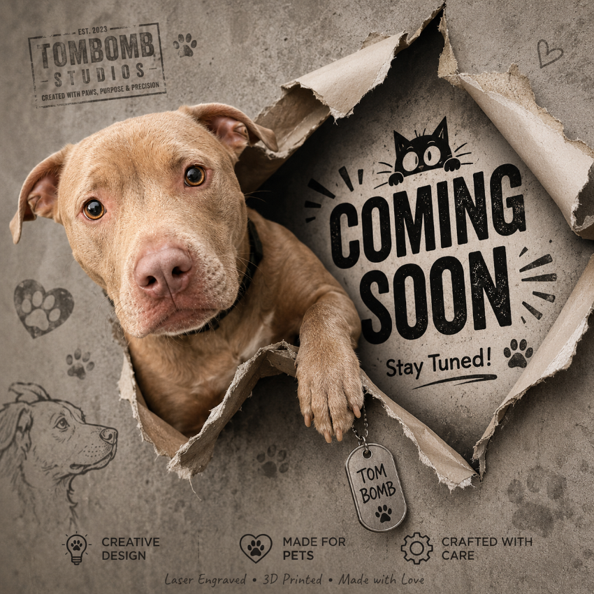 A lab-mix dog peers through torn paper with large 'COMING SOON' text and 'Stay Tuned!' on a textured gray background. The design includes paw prints, heart sketches, a dog head sketch, and the Tombomb Studios branding.