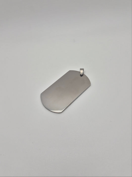 Smooth, stainless steel, military id-style dog tag on a light background